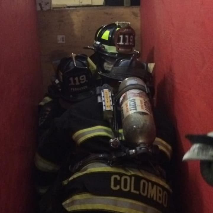 Firefighters practice the &quot;Denver Drill&quot; Saturday at the Millwood fire training center. The technique is used to rescue victims trapped in small spaces.