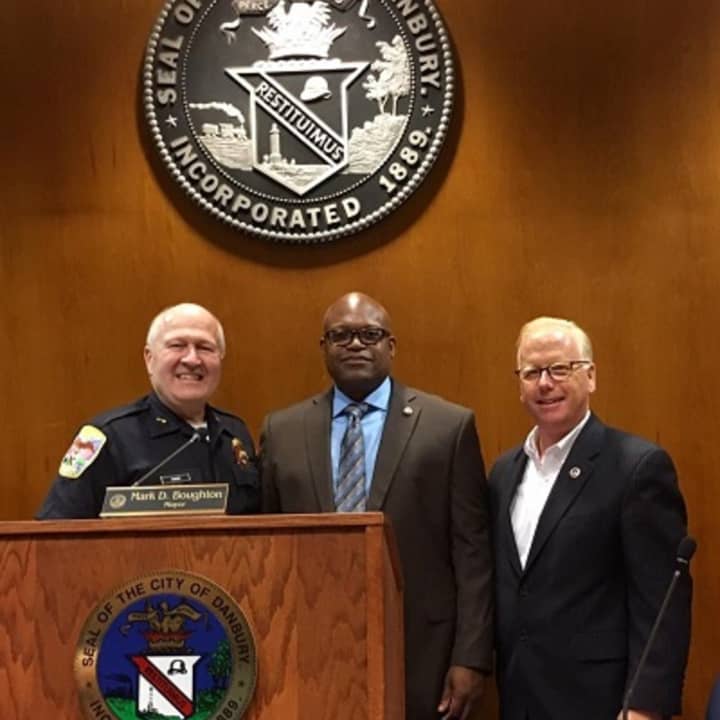 The appointment of Patrick Ridenhour, center, as Danbury&#x27;s top cop was unanimously approved Tuesday by the City Council. At left is Al Baker, who is retiring as police chief in July. Mayor Mark D. Boughton is at right.