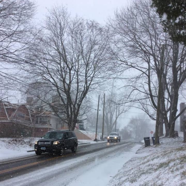 With small flakes flying, enough snow has fallen to cover the roads and make conditions slippery across Fairfield County on Saturday.