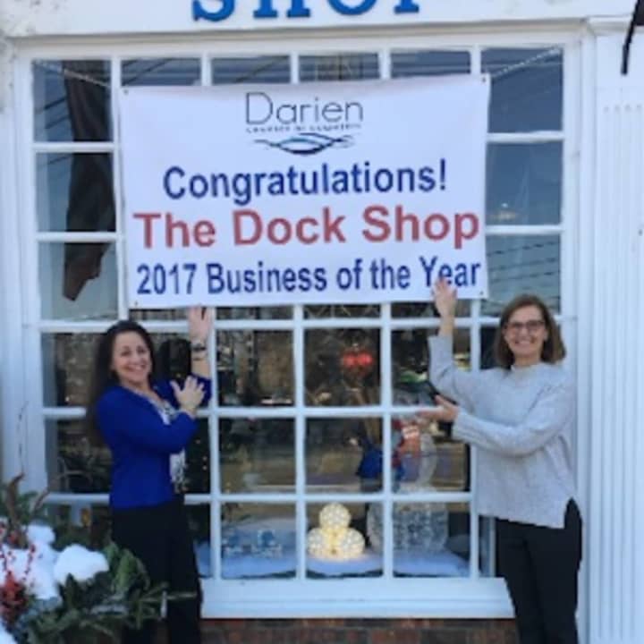 Toni Sabia, owner of The Dock Shop and Susan Cator, DCC president and executive director ,show off the banner
celebrating the awarding of “Business of the Year” to The Dock Shop for 2017.