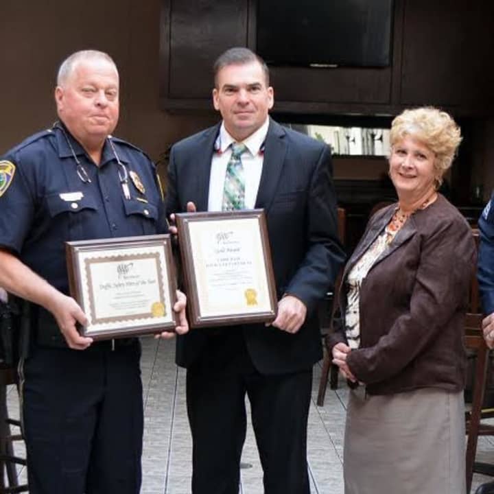 At AAA’s 6th Annual Community Traffic Safety Awards lunch Public Affairs Manager Fran Mayko, third from right presented awards to Police Chief Gary MacNamara, center, and Officer Gary Wikman, left
