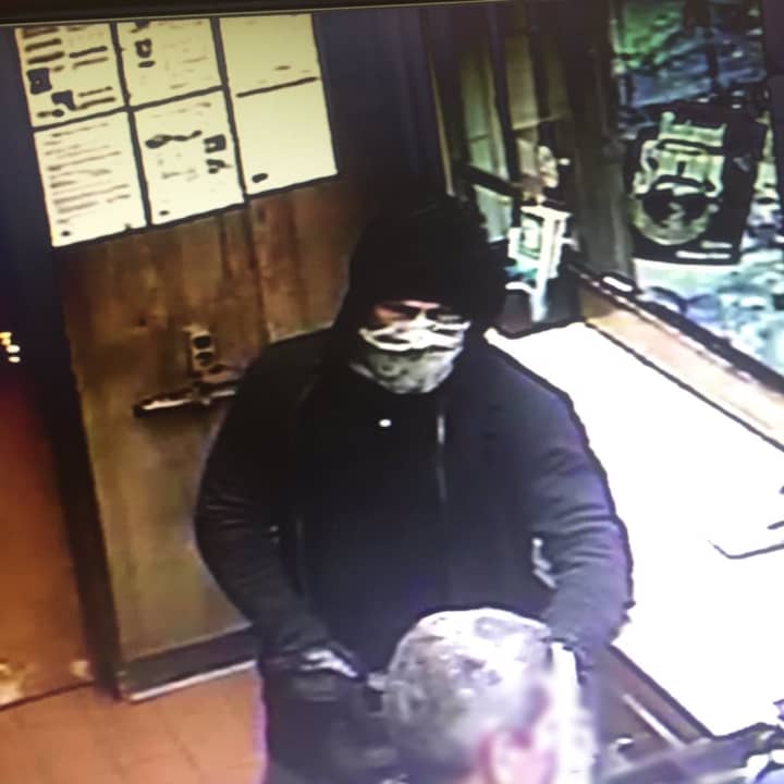 Surveillance footage of the suspect in the robbery of a gas station in Greenwich.