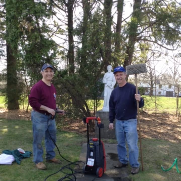 Past Grand Knight Mike Colaluca and Trustee Lee Pino clear the grounds of Notre Dame Convalescent Home.