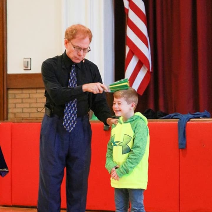 Student takes part in a demonstration with Bradley Fields of &quot;MatheMagic!&quot;