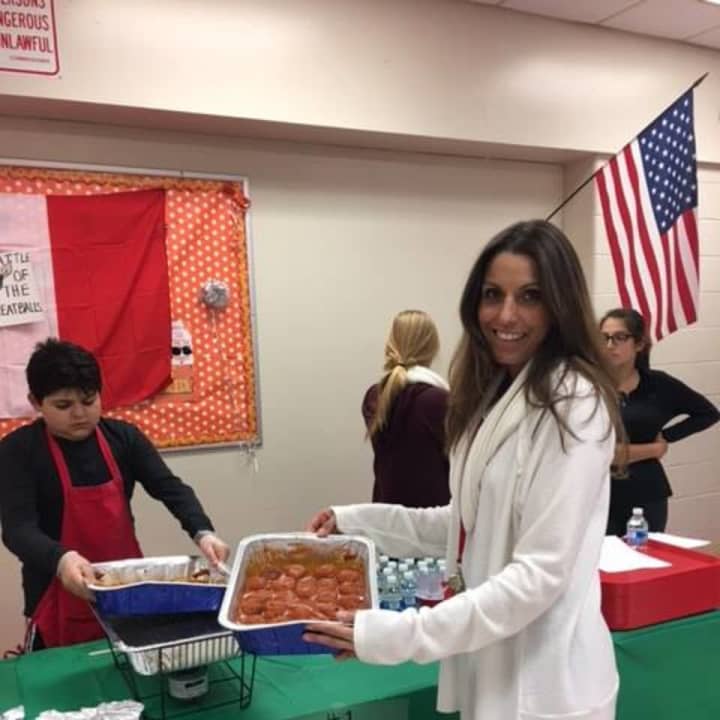 Daniela Savone, teacher and president of the Italian Club, holds a tray of meatballs submitted for a contest and fundraiser at  North Rockland High School.