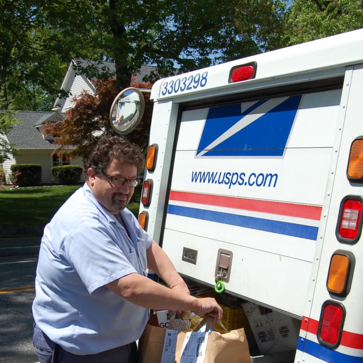 Greenwich mail carrier Sonny Migliaccio picks up bags of food during last month&#x27;s Neighbor to Neighbor food drive