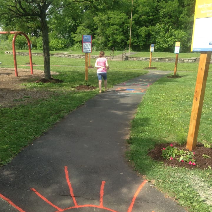 A kid begins to venture down the new Born Learning Trail at Rogers Park in Danbury. 