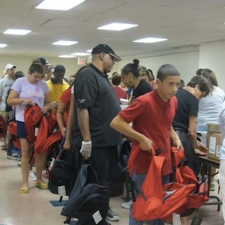 Volunteers fill backpacks with school supplies at the 2012 Empty School Backpack Project, hosted by the Rye-based Helping Hands for the Homeless &amp; Hungry.