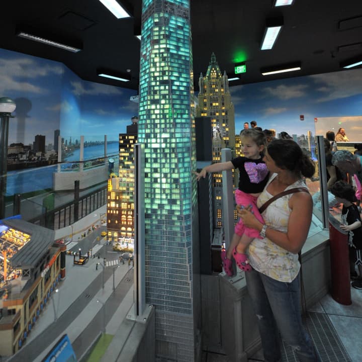 Guests at LEGOLAND Discovery Center Westchester watch a LEGO replica of One World Trade Center light up following a special ceremony unveiling the model last month.