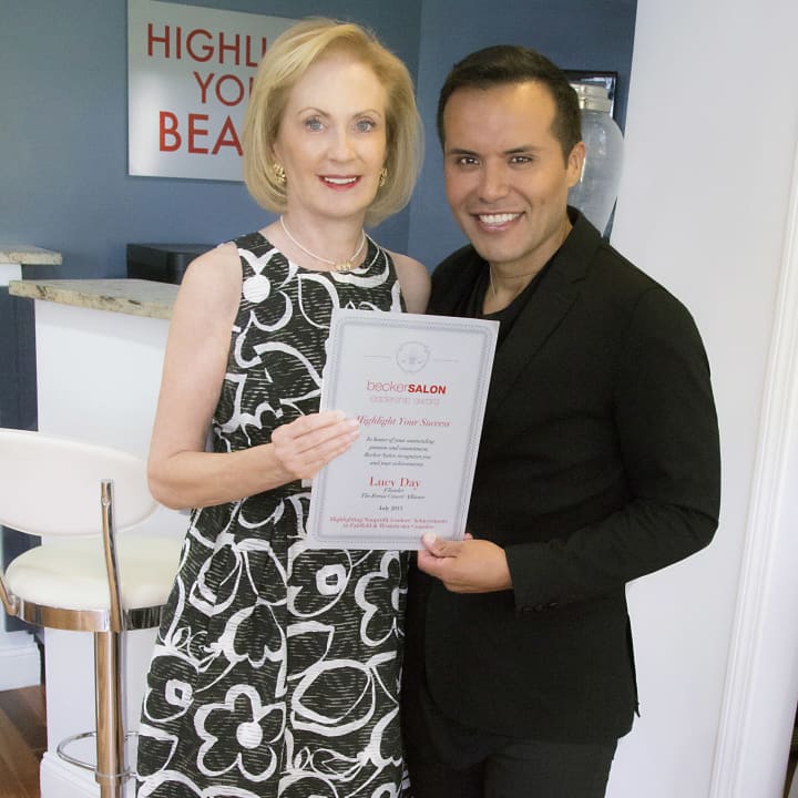 Lucy Day, left, a founding member of the Breast Cancer Alliance, accepted the Becker Salon Leadership Award from salon owner Becker Chicaiza, right.