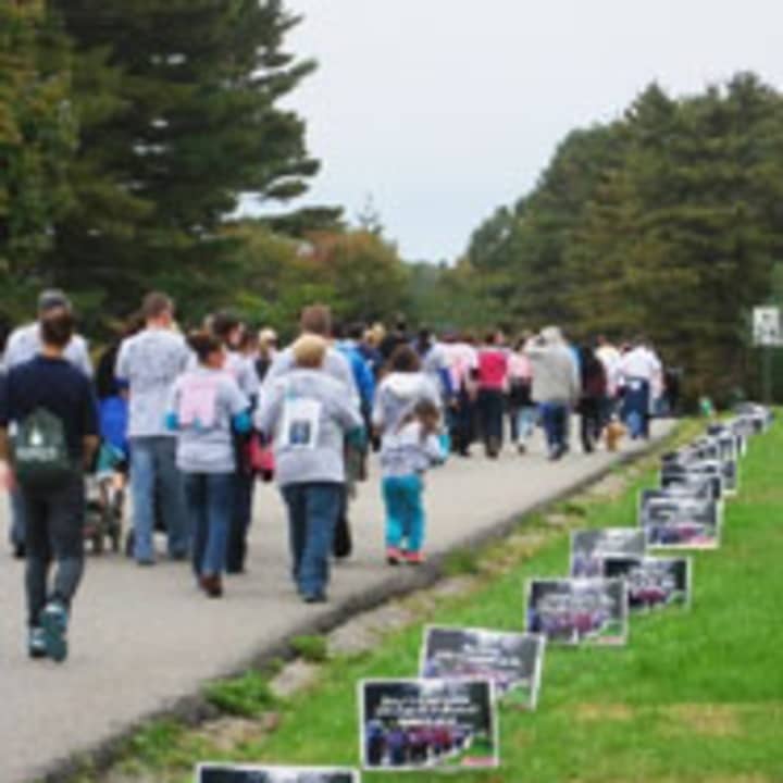 Walkers pass tribute signs along the Walk-A-Thon route. 