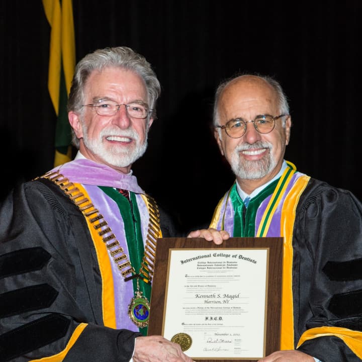 Harrison&#x27;s Dr. Kenneth Magid, right, was recently inducted into the International College of Dentists. 