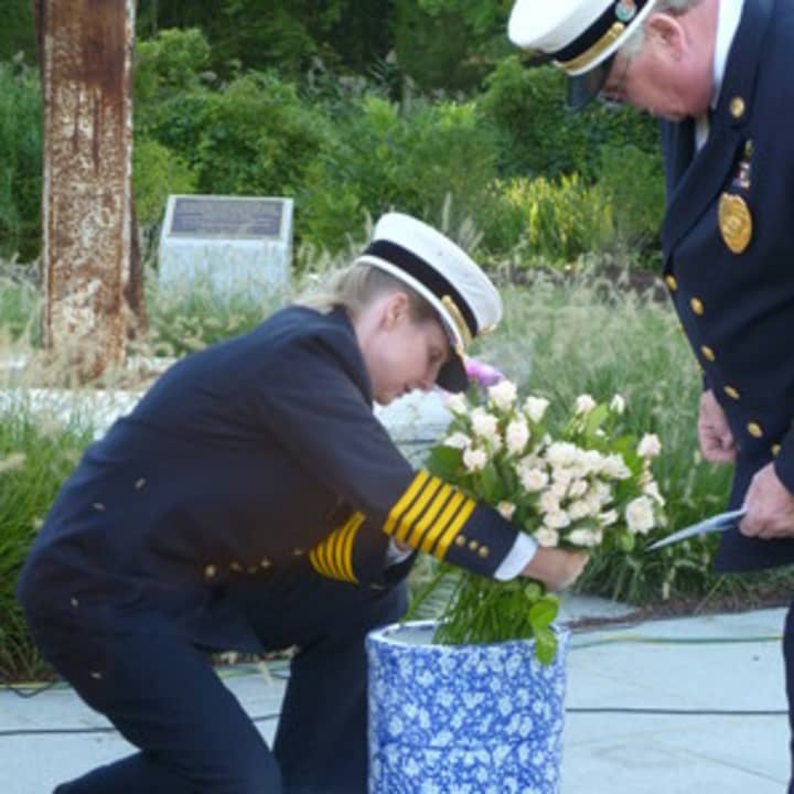 Ridgefield Fire Chief Heather Burford pictured here placing flowers during a 9-11 memorial, will be leaving Ridgefield for a new position in Florida. 