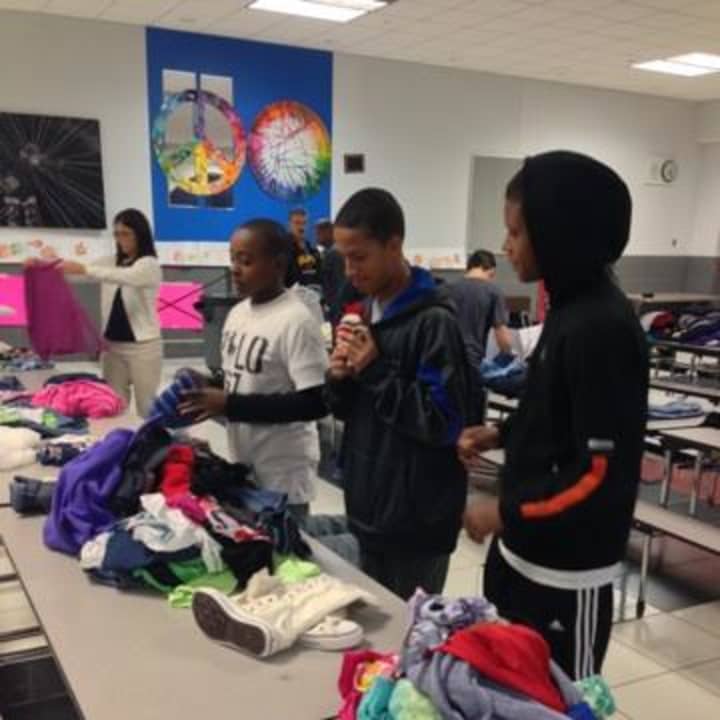 Seventh- and eighth-graders sort clothes for the clothing drive. 