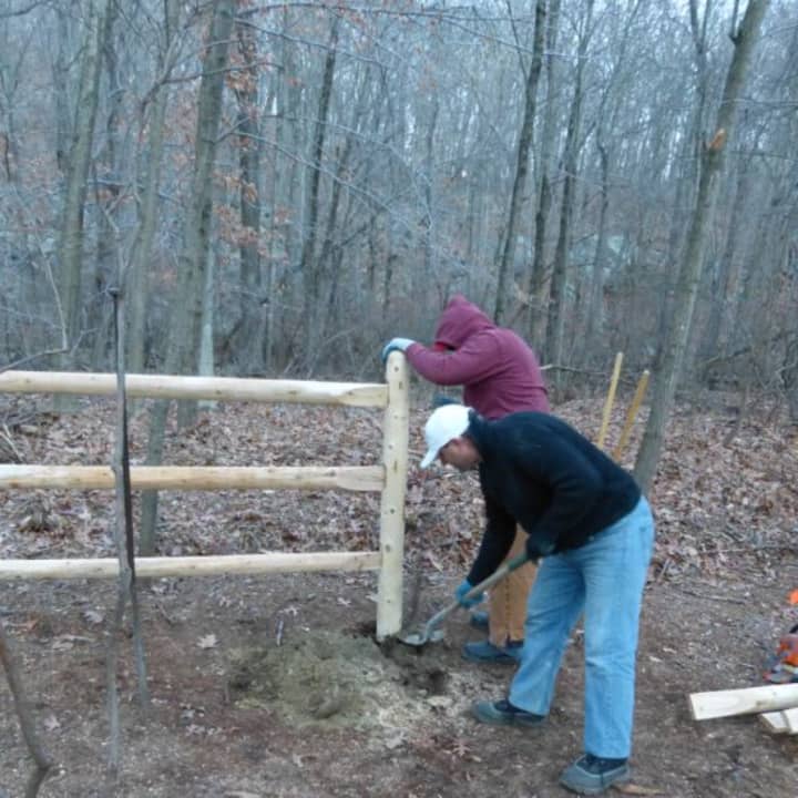 Members of the Yorktown Dog Park Committee construct a fence for the off-leash dog park at Sylvan Glen Park Preserve in Yorktown.