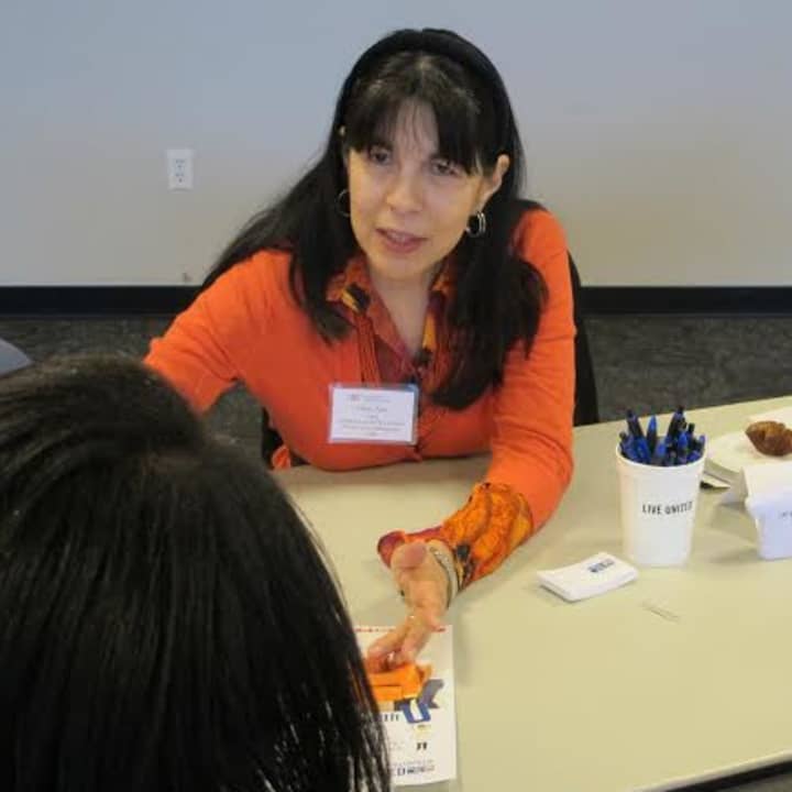 Mary Ann Luna of United Way-Pace University Wilson Center Not-For-Profit Management Center explains services to an attendee.