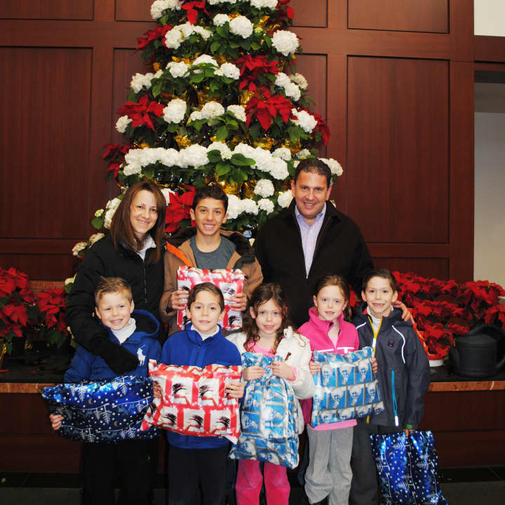 Marla and Keith Sernick and their six children, Jake (top center), Carson, Cooper, Katharine, Chloe and Reagan (l-r) visit Greenwich Hospital on Christmas Eve to deliver special presents for hospitalized children.