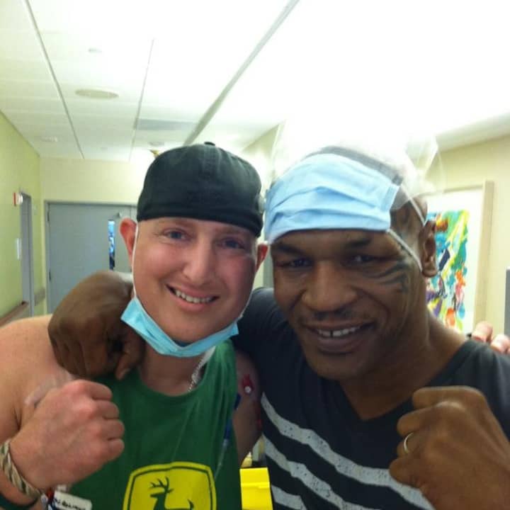 Jason Needle, two-time cancer survivor, poses with former boxer Mike Tyson. 