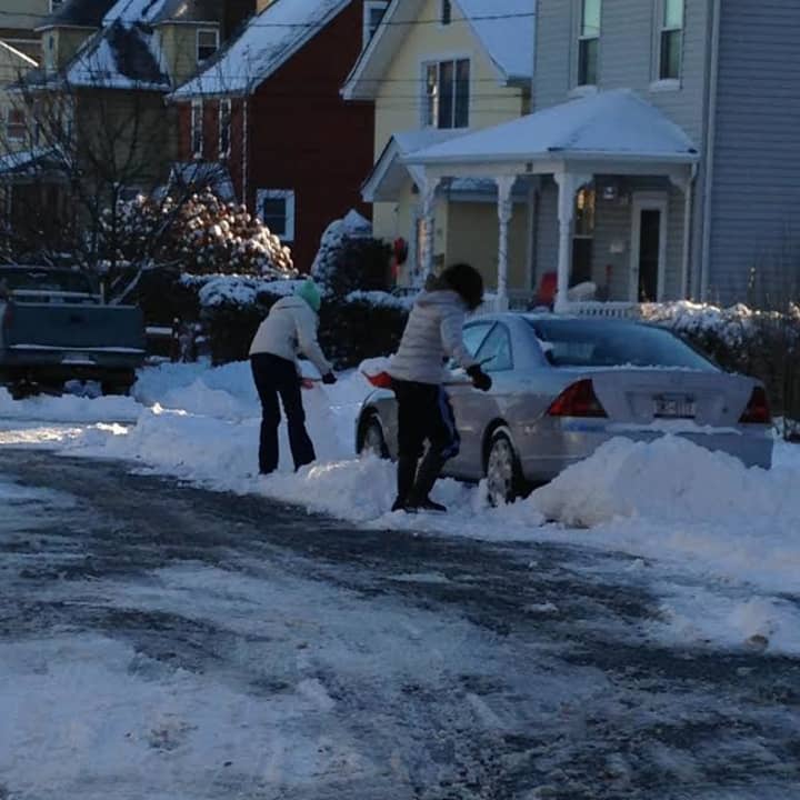 Jordan Levy and her mother Elaine shoveling out their car on Saturday.