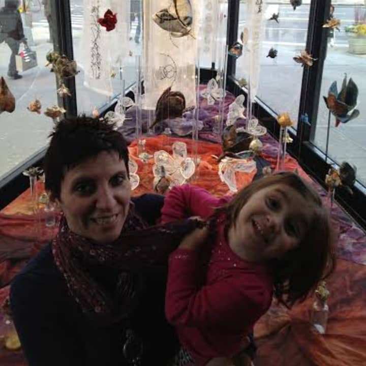 Serena Buschi and her daughter wit one of her pieces on exhibit at the Flatiron Prow in Manhattan.