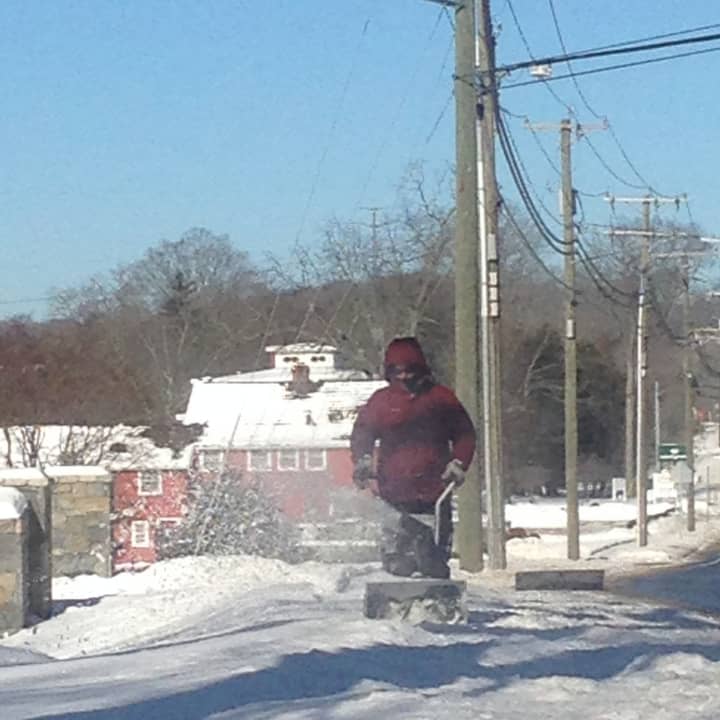 A snowblower is used outside of Our  Lady of Fatima Church in Wilton to clear the sidewalk.