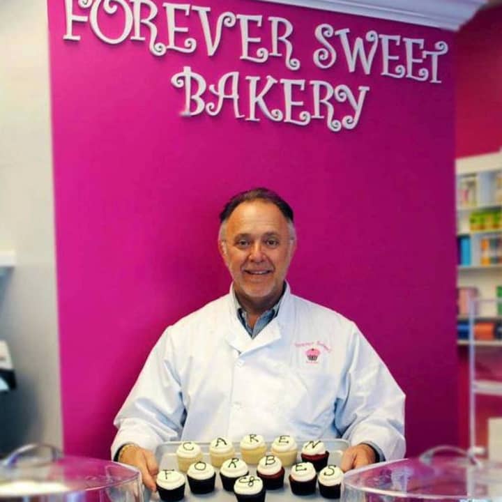 Sky Mercede, co-owner of Forever Sweet Bakery in Norwalk, shows off some of his bakery&#x27;s signature cupcakes.