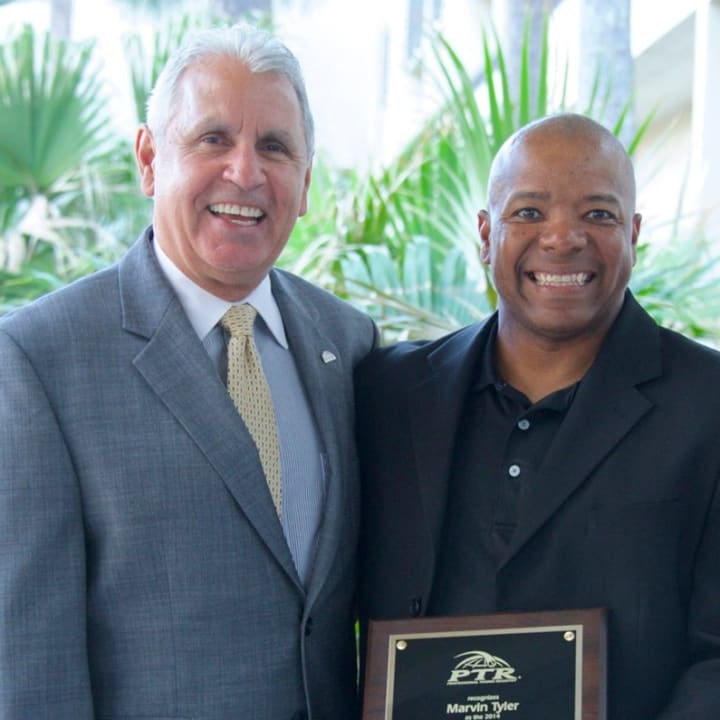 Norwalk&#x27;s Marvin Tyler, right, receives the Professional Tennis Registry&#x27;s member of the year award for Connecticut from  PTR board president Jorge Andrew.