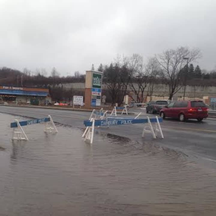 The road is flooded across all four lanes of Backus Avenue near the Danbury Fair Mall. 