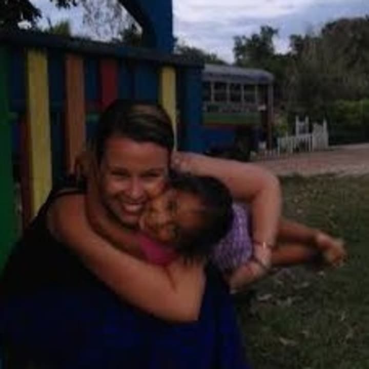 Lindsay Seekircher of Peekskill, a member of Tarrytown-based Fortress Bible Church, volunteers on medical aid missions to impoverished nations. She gets a hug from a young child on her most recent trip in March to Belize.