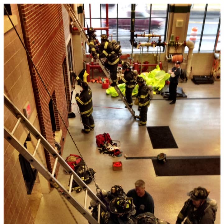 Norwalk firefighters take part in a simulated rescue inside the new fire headquarters on Connecticut Avenue. 