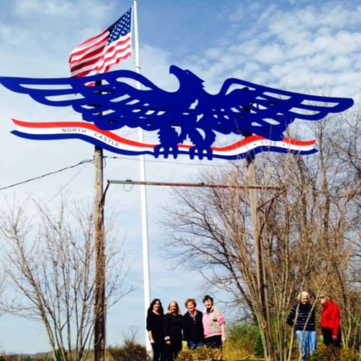 Armonk&#x27;s eagle committee poses with the refurbished town eagle. 