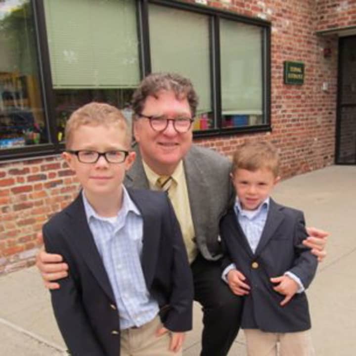 Chapel School Principal James Dhyne poses with his replacements for the day, third-grader Charlie and his brother Zachary.