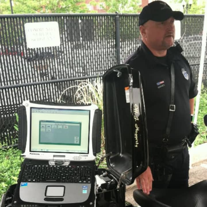 Norwalk Police Department Officer John Haggerty talks about the new Mobile Data Terminal, a laptop, pictured, on the NPD&#x27;s Harley Davidson motorcycle. He said the unit along with the E-printer (not pictured) will cut the time of traffic stops.