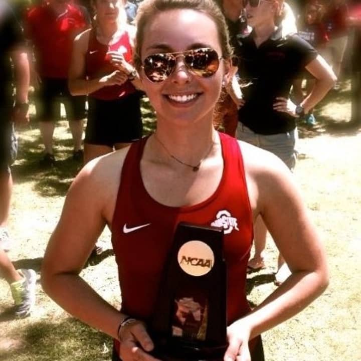 Sami Jurofsky of holds a trophy after helping Ohio State win the NCAA women&#x27;s rowing championship Sunday in Indianapolis.