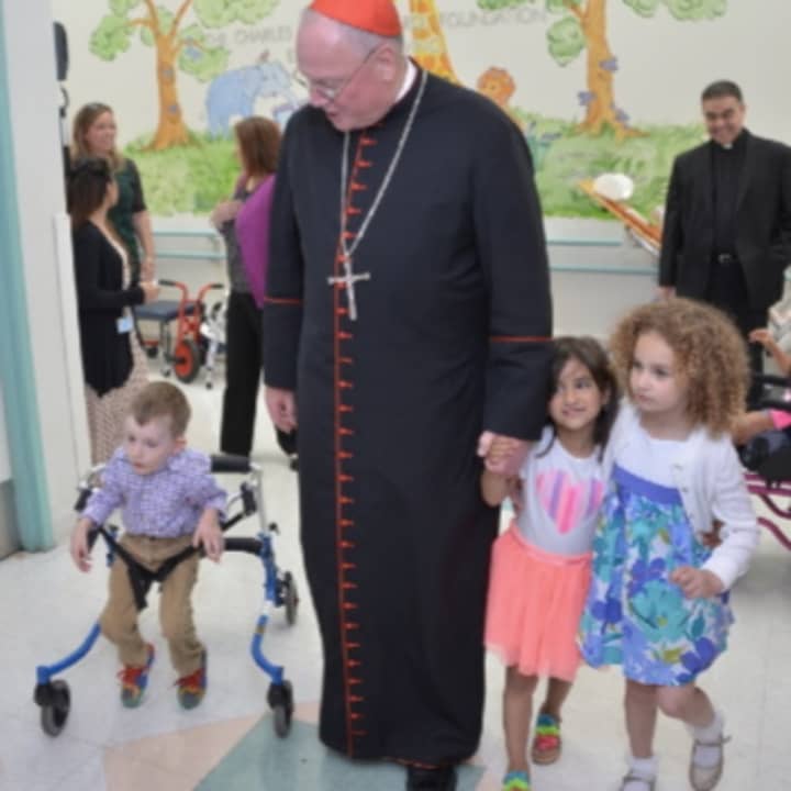Cardinal Timothy Dolan tours the John A. Coleman School in White Plains with students.