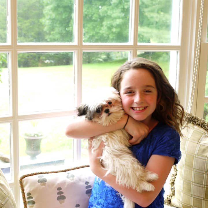 Hayley Negrin of Weston with her new puppy, Emmy, that she named in honor of being nominated for an Emmy at age 11 for her voice acting as Peg on the animated PBS series &quot;Peg + Cat.&quot; 