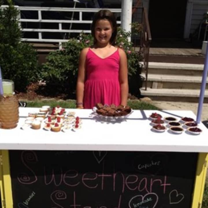 Emily Cartwright, seen here at her Sweetheart Stand, is raising funds to help children with cancer.