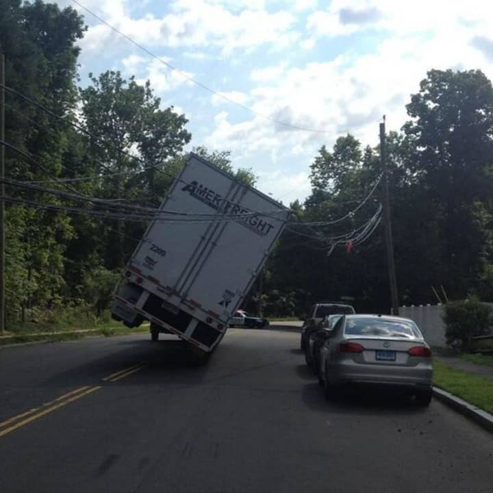 A truck is caught in power lines at Strawberry Hill Avenue by Norden Place in Norwalk on Friday morning. 