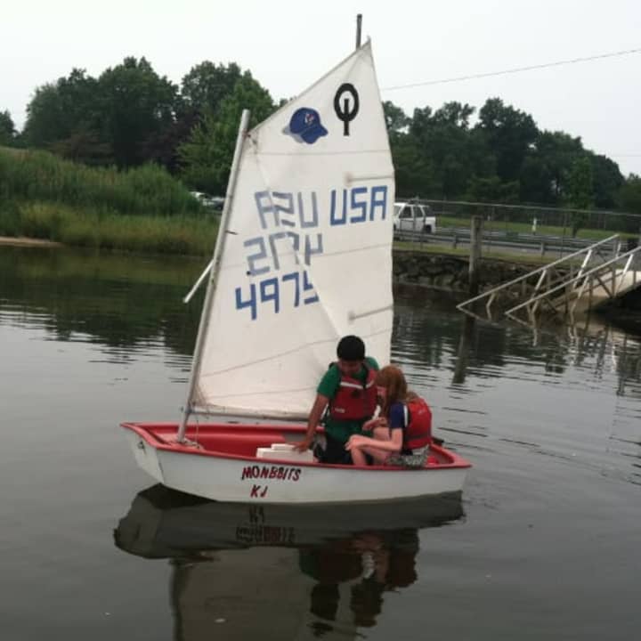 Diangelo Marroquin, 11, and Priscilla Sawyer, 11, take an Optimist sailboat out as part of the Stamford Young Mariners program.