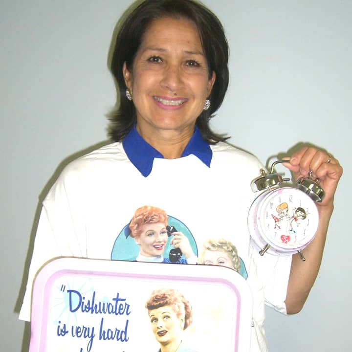 Annette Robertson, displays a few of the &quot;I Love Lucy&quot; items that will be part of the Nutmeg Festival Silent Auction  a clock, a tray and a T-shirt, which she is modeling. 