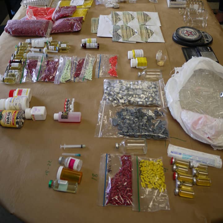 Fairfield police seized a large amount of steroids, human growth hormone, drug paraphernalia, capsule presses, cash and firearms from the homes of two suspected leaders of a distribution ring in Fairfield County.