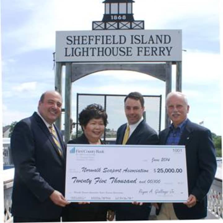 Robert Granata, president and COO of First County Bank, Irene Dixon, president of the board of trustees of the Norwalk Seaport Association, Inc., Mike Reilly, Oyster Festival chairman/trustee and Rey Giallongo, chairman and CEO of First County Bank. 