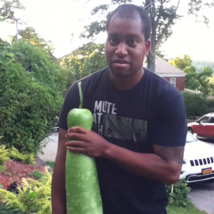 Christine Chestnut&#x27;s son showing off the size of the vegetable 