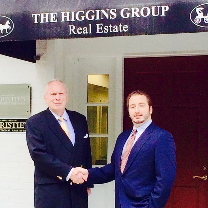 Rick Higgins, left, of the Higgins Group, and Andreas Senie, EAC Founder shake hands on their partnership.