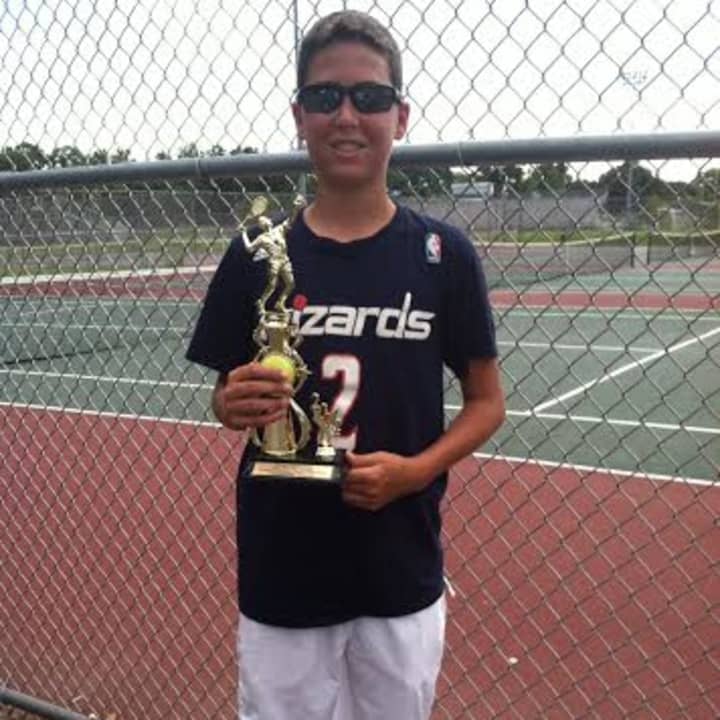 A trophy winner in a USTA Tournament condcuted by Slammer Tennis World of Norwalk shows his wares.