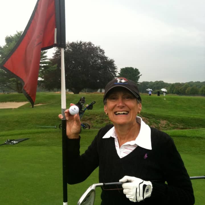 Allison Tane poses with her hole-in-one ball from the eighth hole during the Longshore Women&#x27;s Golf Association Fall Cup.