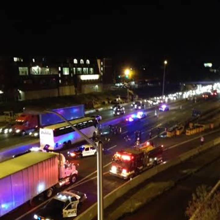 A coach bus, far left, is stopped on I-95 north in Norwalk after a state trooper-involved shooting. 