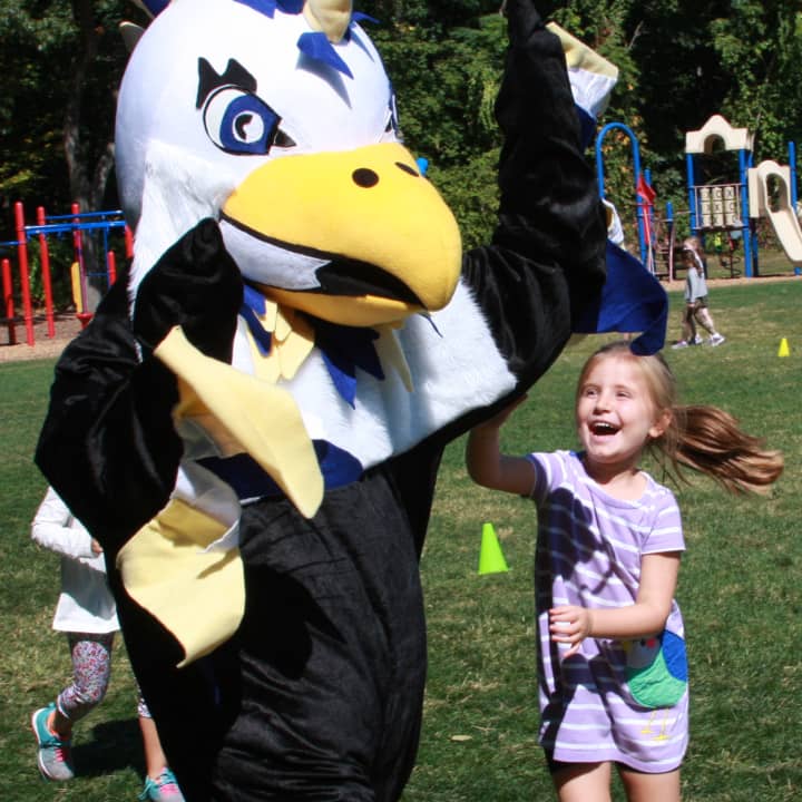 Sophie McCleary gives a high-five to the Holmes Hawk.