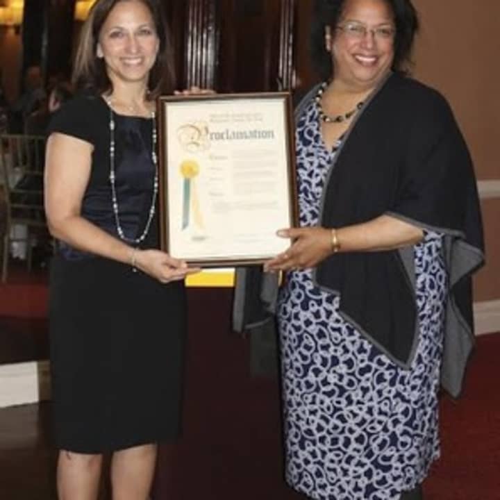 Shirley Acevedo Buontempo, founder and executive director of Latino U College Access, and Iris T. Pagan, executive director, Westchester County Youth Bureau, display a Westchester County proclamation at an event that honored county students.