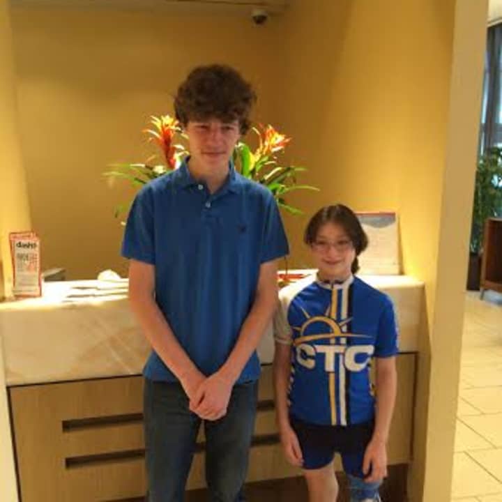 Andrew Day, left, a high school senior, will run the New York City Marathon for the Southport-based Connecticut Challenge. He is shown with Maya Oberstein, who was the co-chair of the Challenge&#x27;s annual summer bike ride.